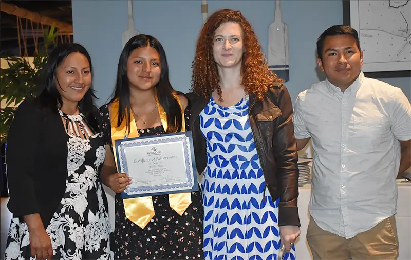 Amelia at graduation with coach and family
