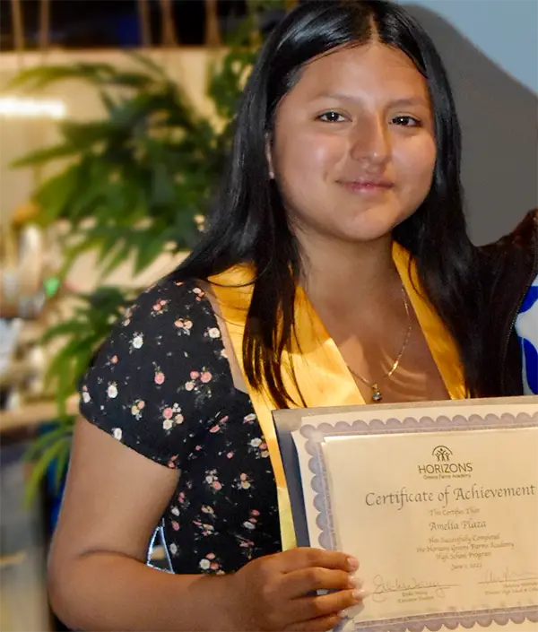 Amelia Plaza holding certificate of achievement