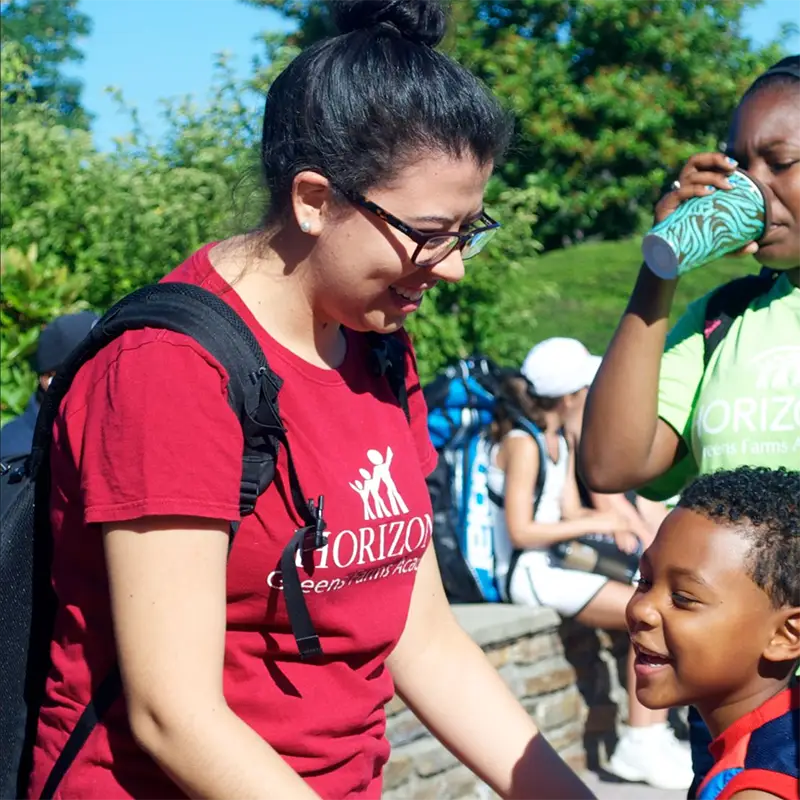 Brenda greeting a student at Horizons GFA