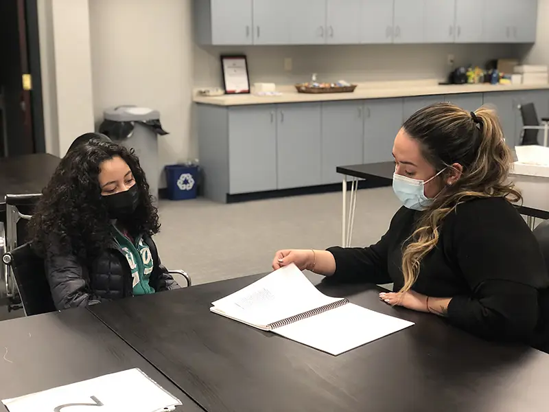 Cynthia helping student