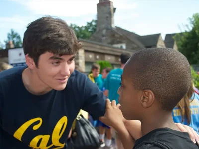 Michael Pavlis greeting a student